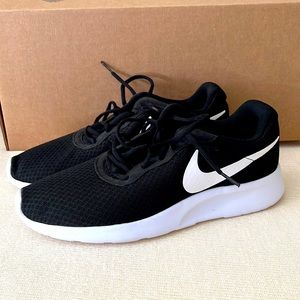 Black and white Nike running shoes. Worn once. Excellent condition.